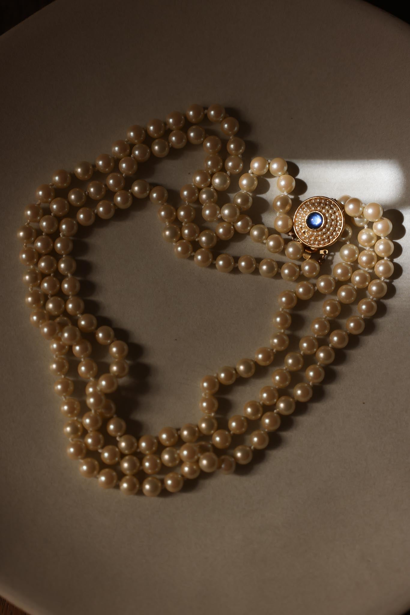 Gold-Tone Triple-Strand Faux Pearl Necklace with Blue Rhinestone Clasp