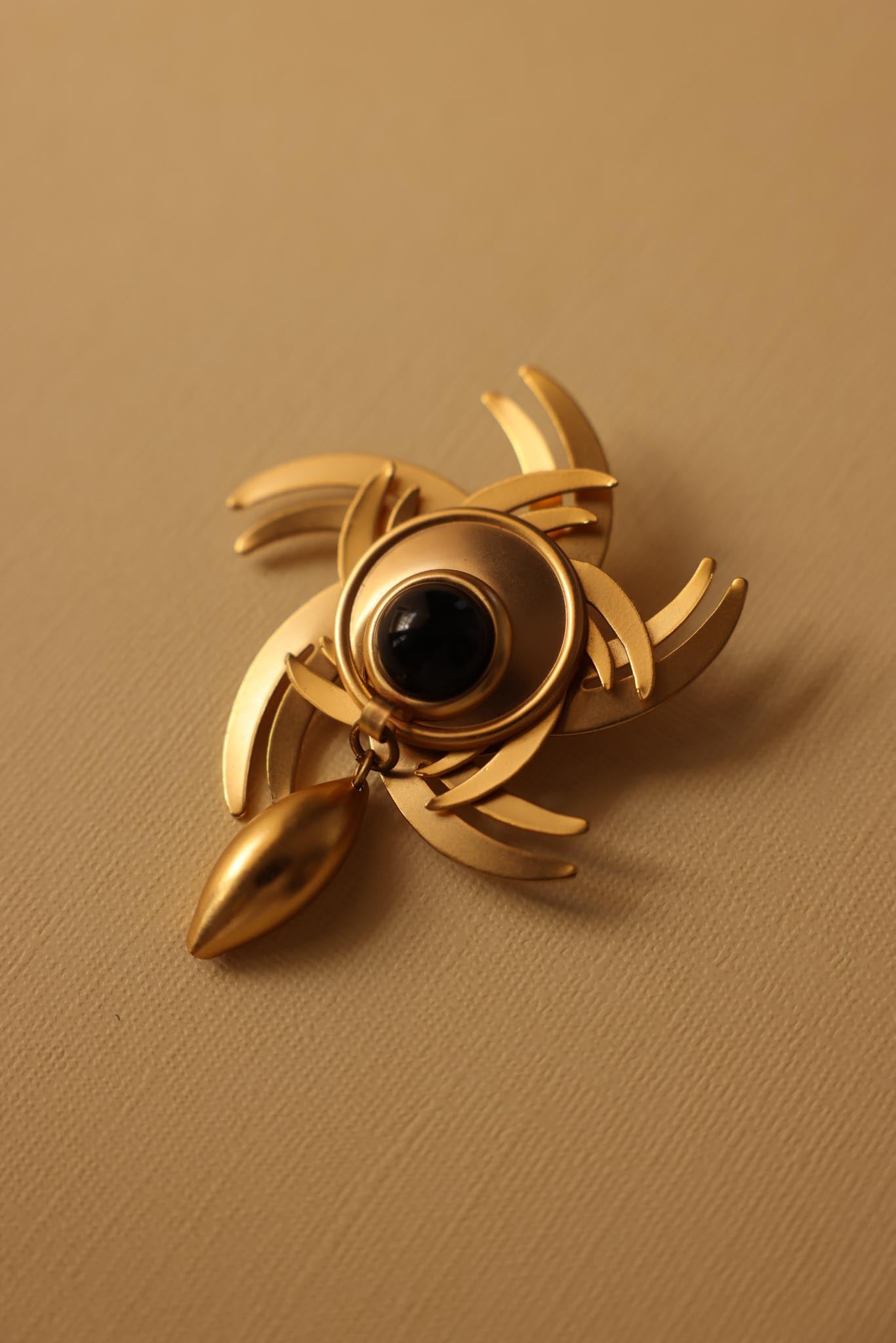 Solar Bloom Brooch with Black Cabochon – Matte Gold