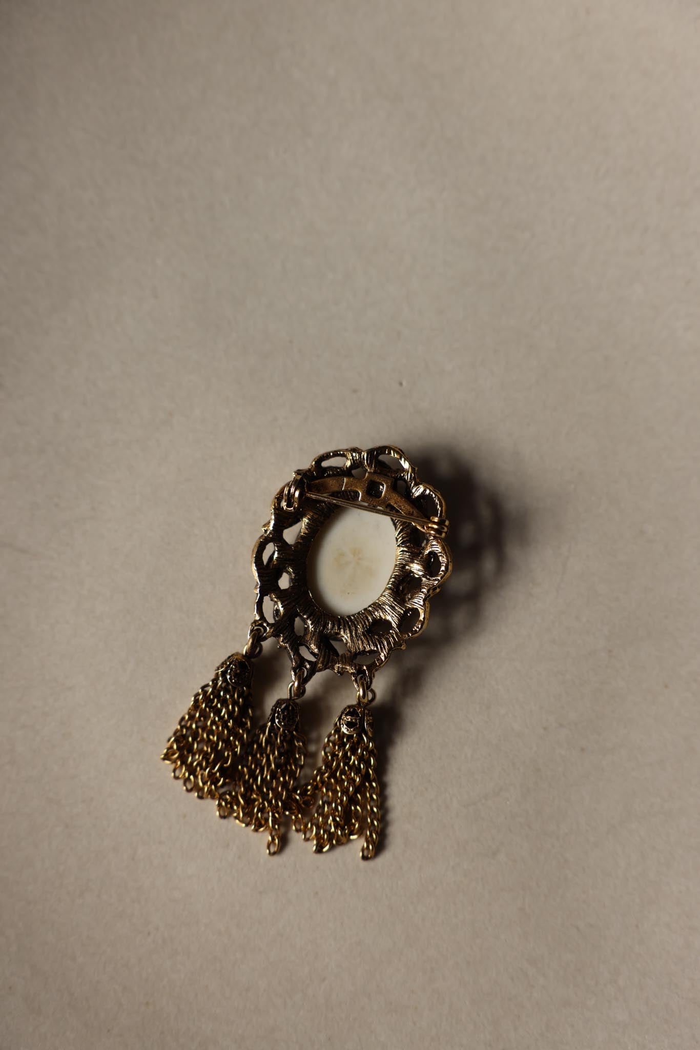 Gold Tone Monogram Tassel Brooch