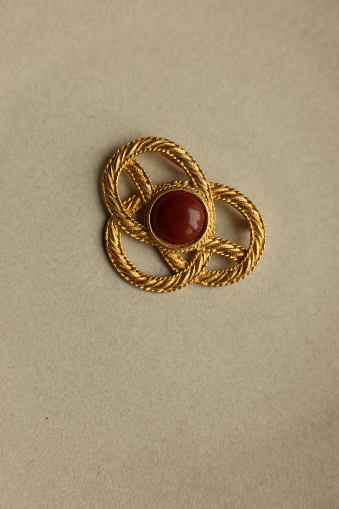 JJ Gold Tone Knot Brooch With Brown Cabochon