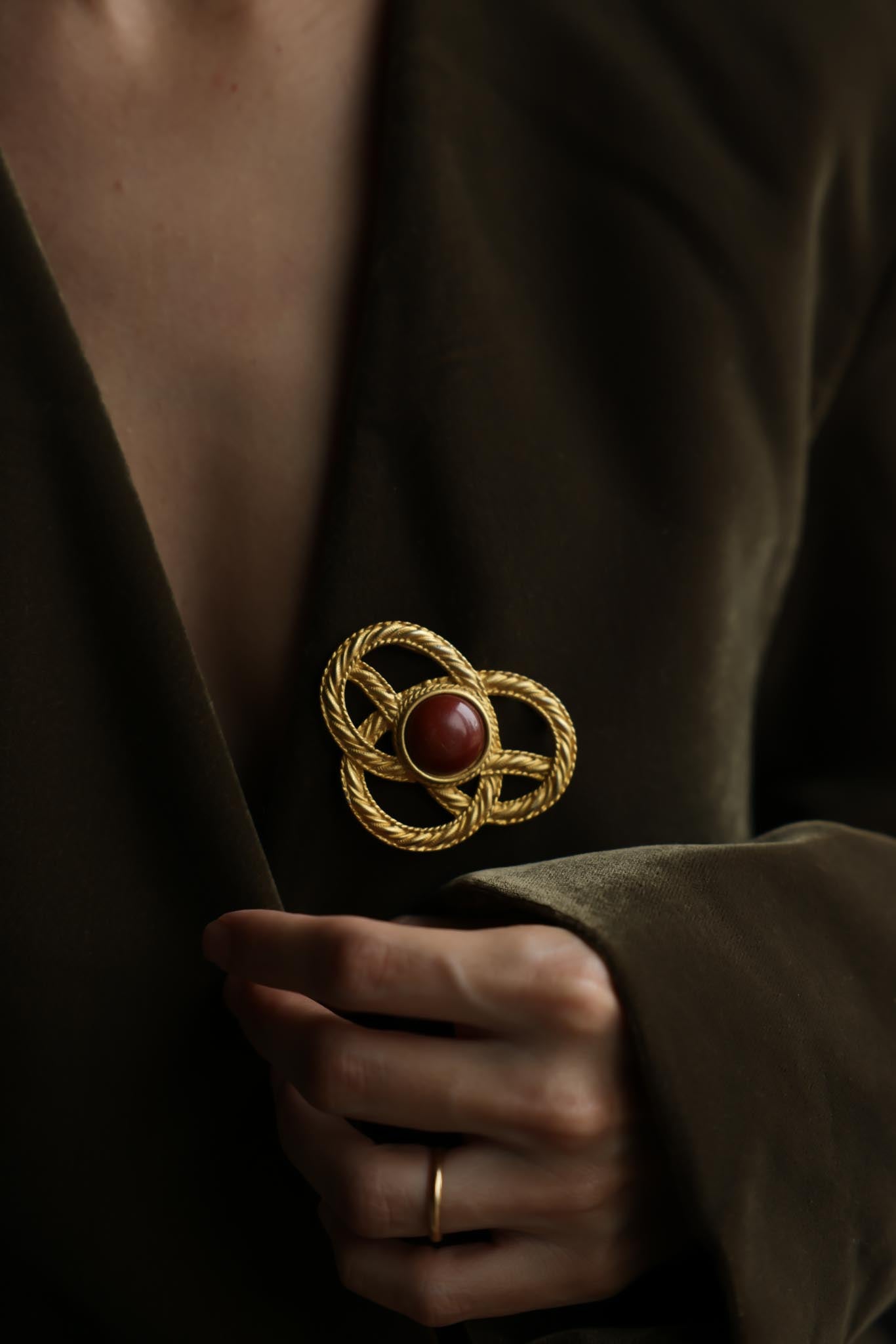 JJ Gold Tone Knot Brooch With Brown Cabochon