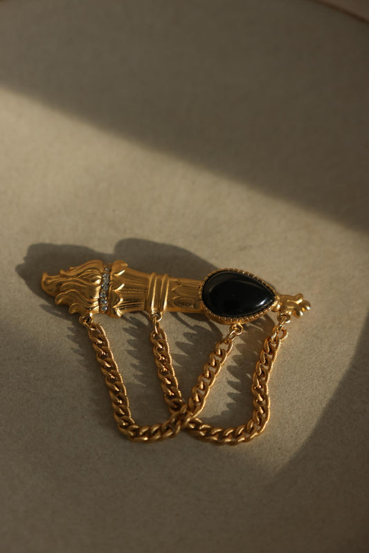 Matte Gold-Tone Draped Chain Brooch with Black Teardrop Center