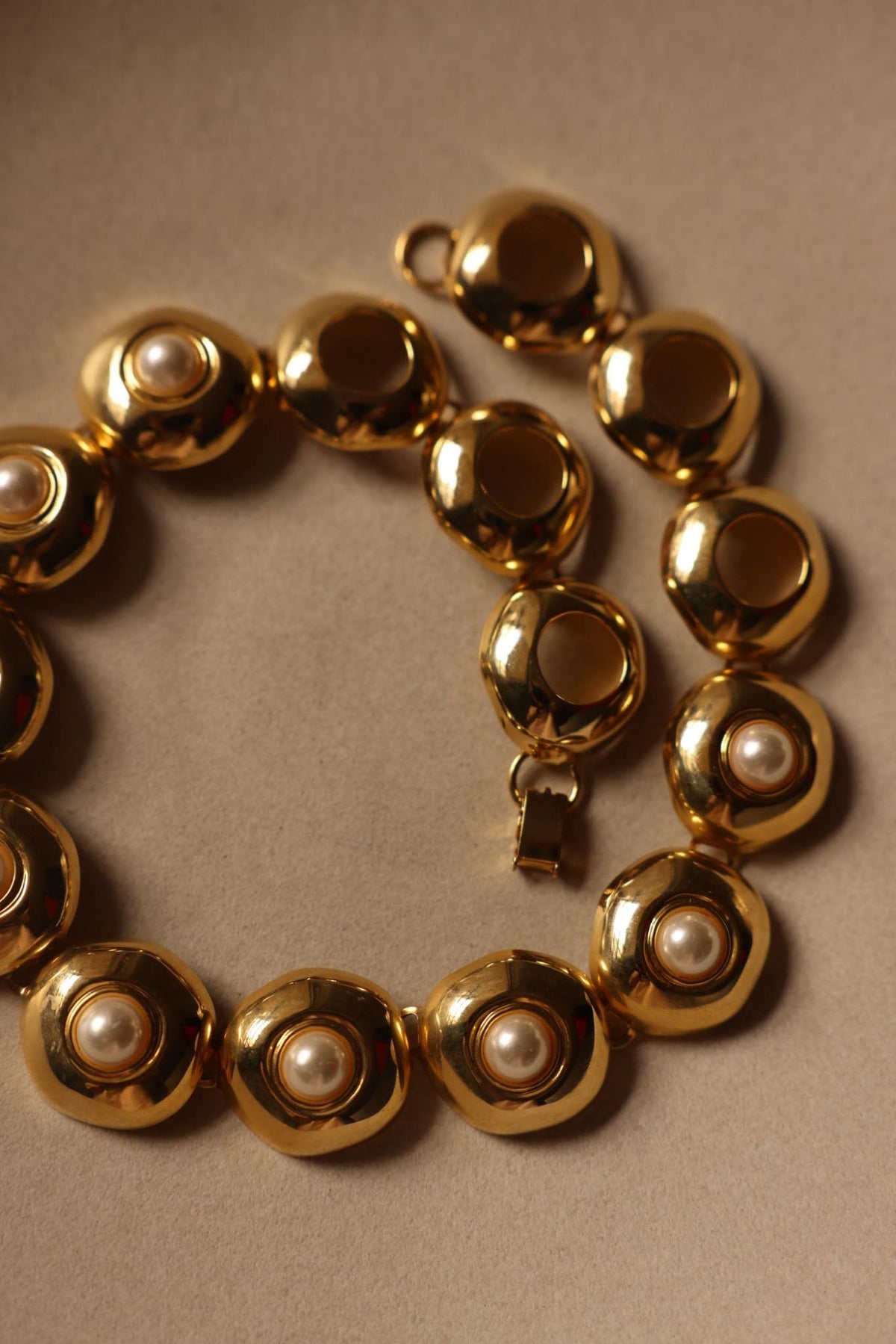 Gold tone domed faux pearl link collar necklace laid flat with box clasp
