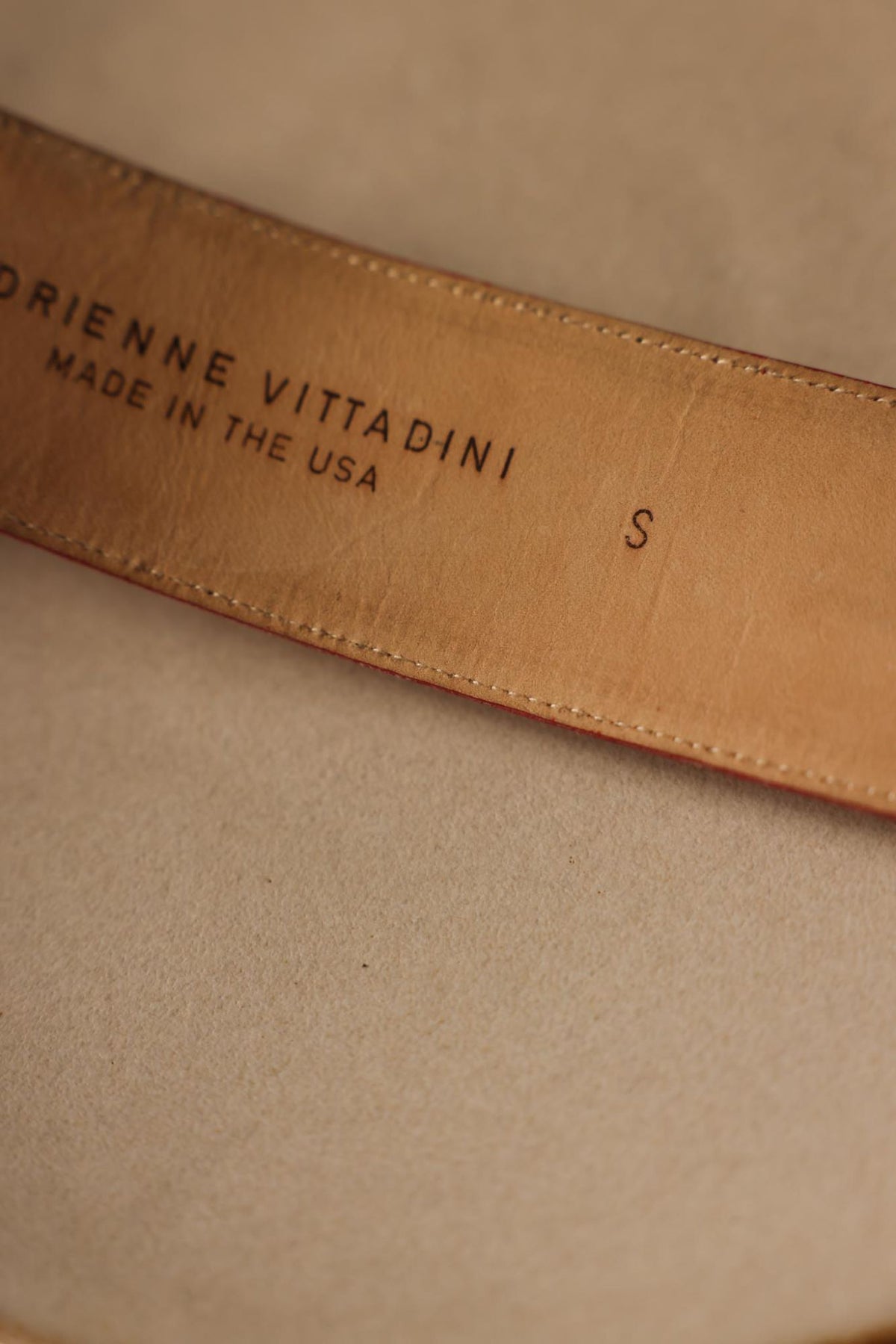 Close-up of Adrienne Vittadini maker's stamp on leather lining
